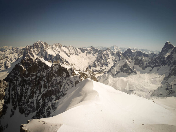 Linia narciarzy w Vallee Blanche, Chamonix, Francja. Bardzo turystyczne miejsce i słoneczny dzień, bez chmur - Zdjęcie, obraz