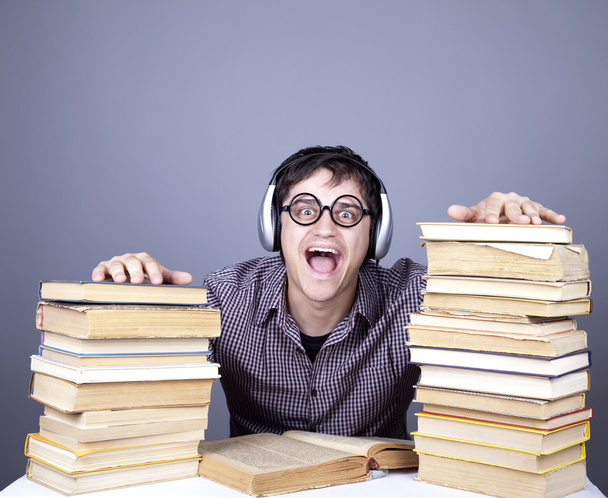 The young student with the books and headphone isolated. - Photo, Image