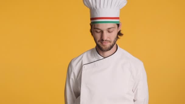 Professional chef in uniform happily smiling in camera over colorful background - Footage, Video
