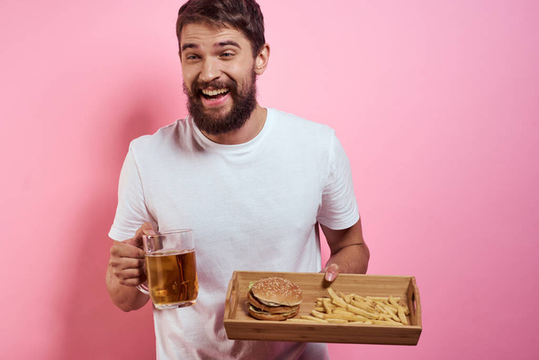 Homem com bandeja de fast food e caneca de cerveja batatas fritas fast food vista cortada - Foto, Imagem
