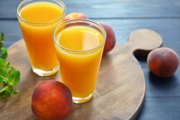 Glasses of fresh peach juice on table - Fotografie, Obrázek