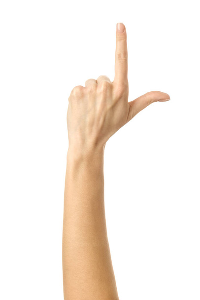 Pointing up. Woman hand with french manicure gesturing isolated on white background. Part of series - Foto, afbeelding