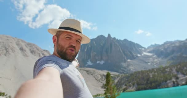Hombre guapo teniendo chat de vídeo en el teléfono inteligente al aire libre compartir aventura de viaje - Imágenes, Vídeo