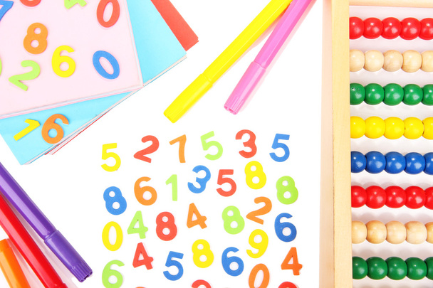Colorful numbers, abacus, books and markers, isolated on white - Photo, image