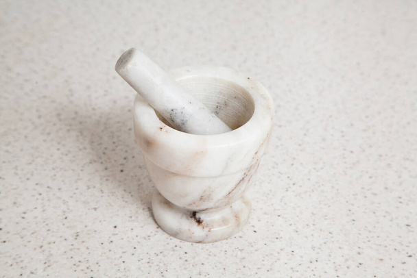 Granite white mortar and pestle with selective focus - Photo, Image