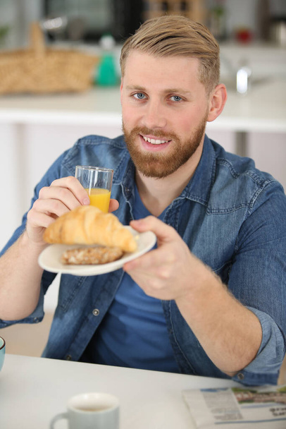 portrait of healthy adult smiling and having breakfast - Фото, изображение