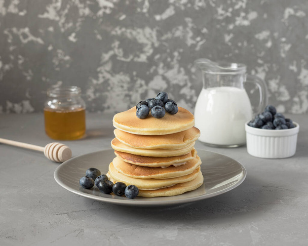blueberry pancakes on a plate. tasty breakfast. - Фото, изображение