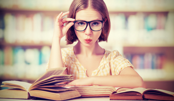 funny girl student with glasses reading books - Photo, Image