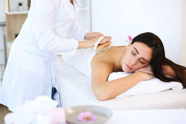 Woman enjoying during a back massage at a spa. - Fotó, kép
