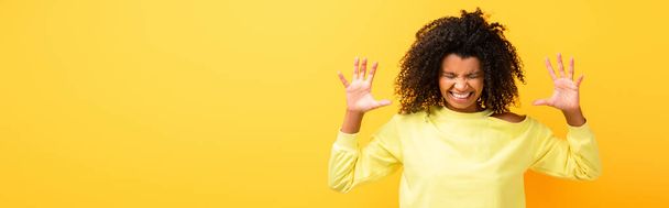 angry african american woman in sweatshirt on yellow, banner - Foto, immagini