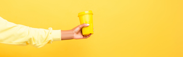 cropped view of african american woman holding reusable cup on yellow - Photo, Image