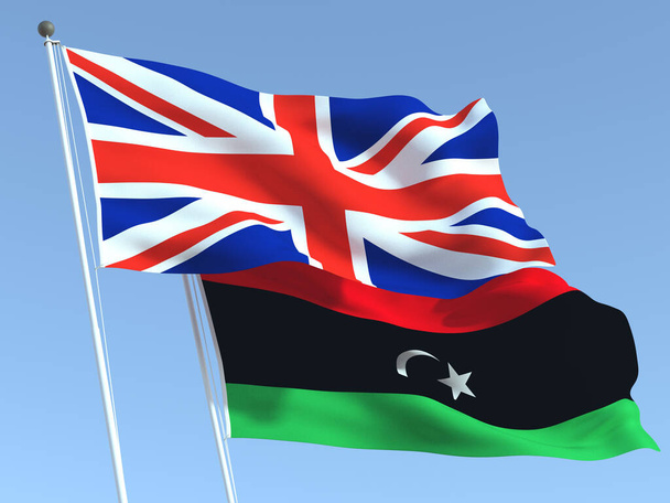 Δύο κυματιστές σημαίες του Ηνωμένου Βασιλείου και της Λιβύης στον γαλάζιο ουρανό. Υψηλής ποιότητας επιχειρηματικό υπόβαθρο. 3D εικονογράφηση - Φωτογραφία, εικόνα