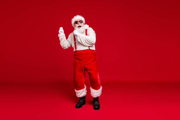 Full length body size view of his he handsome cheerful cheery glad bearded Santa father hipster dancing having fun christmastime celebratory isolated bright vivid shine vibrant red color background - Foto, afbeelding