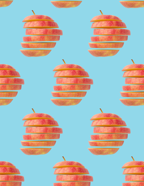 Creative layout with fresh ripe sliced red apples on blue background  - Foto, afbeelding