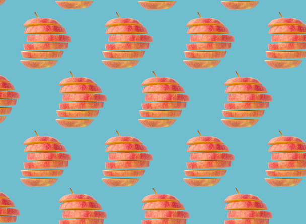 Creative layout with fresh ripe sliced red apples on blue background  - Фото, изображение