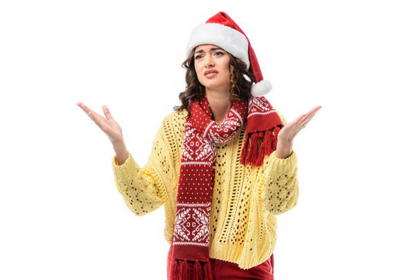 displeased woman in santa hat and scarf gesturing isolated on white  - 写真・画像
