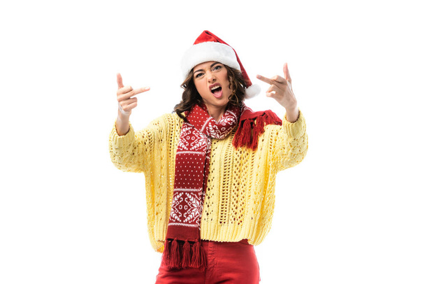young woman with open mouth, in santa hat and scarf showing middle fingers isolated on white  - Фото, зображення