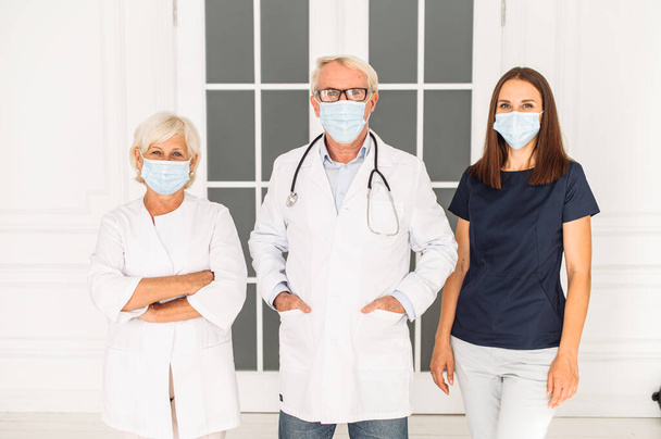 Clinic personnel with face masks and stethoscope - Fotografie, Obrázek