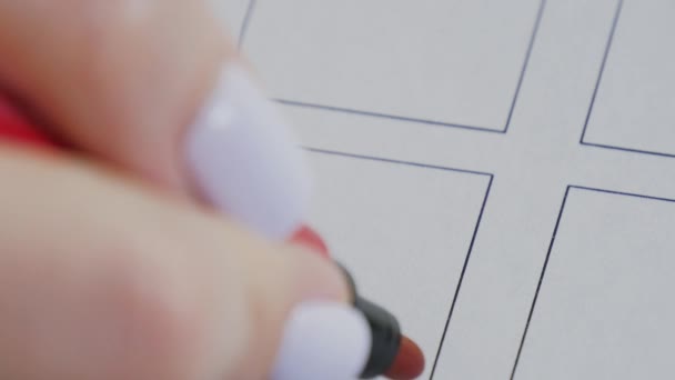 Female hand draws a red cross in vote checkbox. Election and democracy concept - Footage, Video