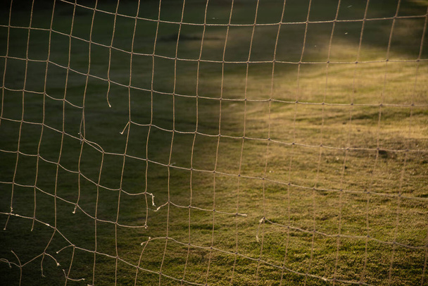 close up of soccer goal net in the morning sun - 写真・画像