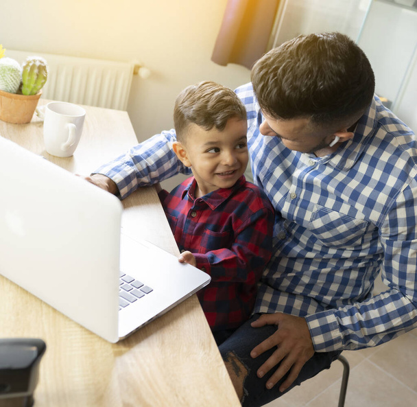 pai com filho usando laptop, escola em casa, teletrabalho - Foto, Imagem