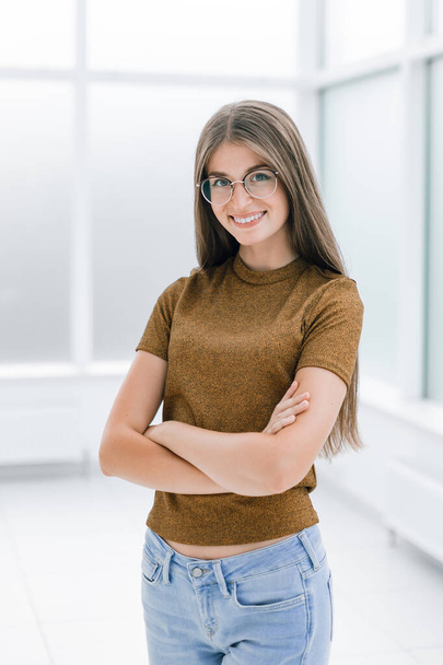 smiling young woman standing in bright office . - Fotografie, Obrázek