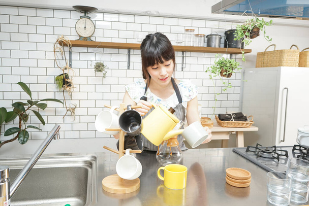 Young woman making some coffee - 写真・画像