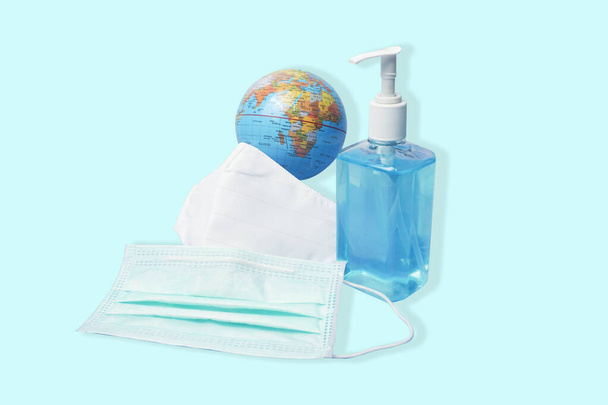 Coronavirus in the world, coronavirus prevention, travel surgical mask and alcohol gel hand sanitizer for prevention concept. - Photo, Image