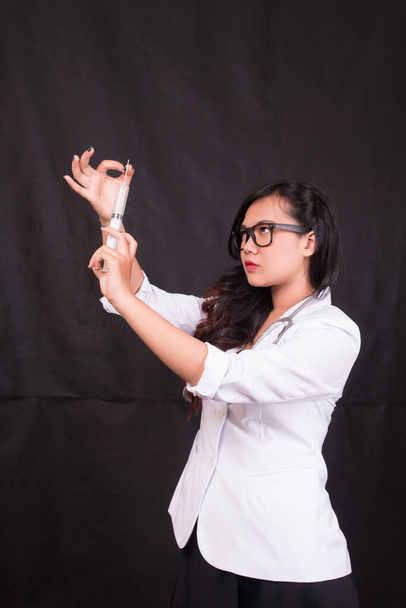 indonesia mujer médico sosteniendo estetoscopio, informe sobre fondo blanco - Foto, imagen