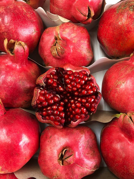 Delicious ripe pomegranates on the market macro  - Photo, Image