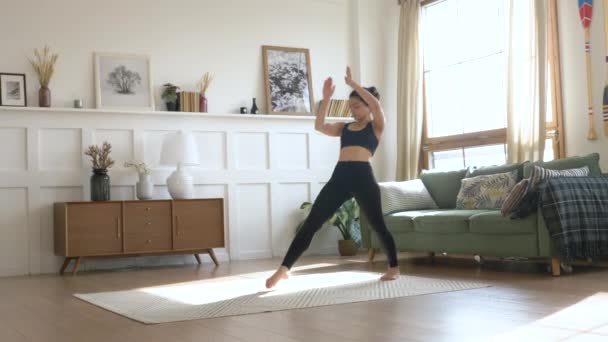 A Young Indian Woman in the Morning, She Does a Stretching Exercise Does Sports Yoga, Black Sportswear Leggings and a Top, a Bright Room At Home - Séquence, vidéo