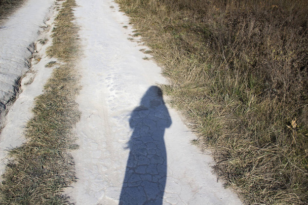 Silhouette of a girl on a chalk road. - Photo, Image