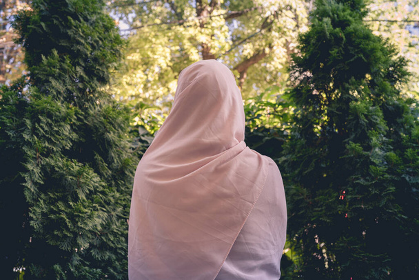 Autumn. Lonely muslim woman in a headscarf  walking in a park, garden. Vintage Toned - Фото, изображение