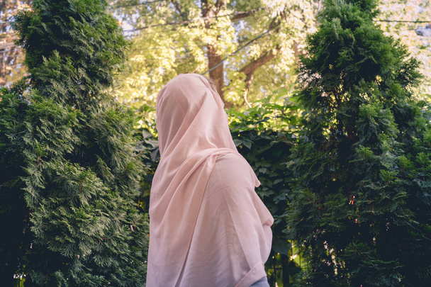 Autumn. Lonely muslim woman in a headscarf  walking in a park, garden. Vintage Toned - 写真・画像