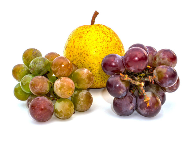 Harvest grapes berries on pears fruits white background. Grape juice. Pear juice. Winemaking. Take a pear. Fruit shop showcase. Grape gardening. Agriculture. Place for text. Dried fruits. - Photo, Image