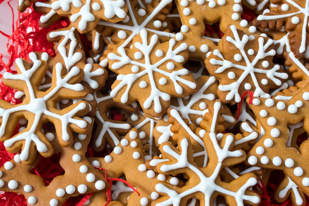 Square frame. Top above high angle closeup overhead view of nice christmas decoration. Gingerbread cookies in the form of snowflakes, arrows, stars and hearts on a wooden brown table - Φωτογραφία, εικόνα