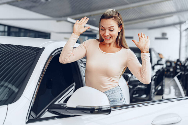 Young attractive caucasian woman sits in her newly bought car - Foto, immagini