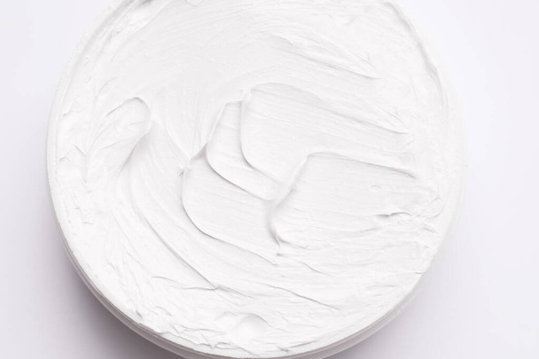 Body and face care cream. Close-up texture. View from above. White background - Photo, Image