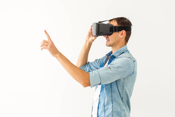 Young man with virtual reality glasses. Modern technologies. The concept of future technology. - Photo, Image