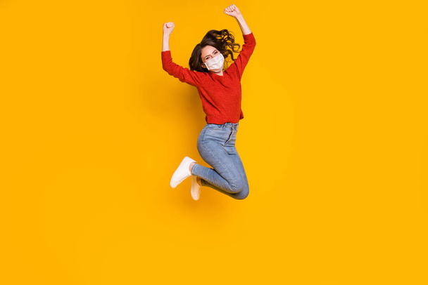 Full length body size view of her she nice attractive lovely wavy-haired girl jumping wearing gauze mask rejoicing win winner isolated on bright vivid shine vibrant yellow color background - Valokuva, kuva