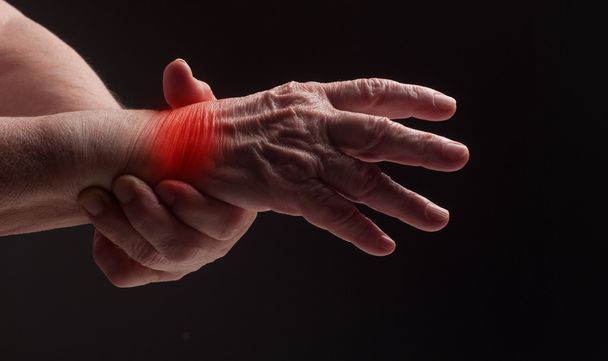 Senior hands. Suffering from pain and rheumatism - Photo, Image