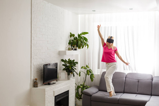 Woman using the virtual reality headset, virtual glasses - 写真・画像