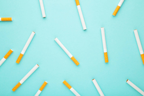 Many cigarettes on a blue background. Top view. - Photo, Image