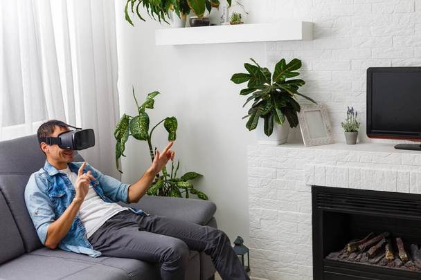 The man with glasses of virtual reality. Future technology concept. - 写真・画像