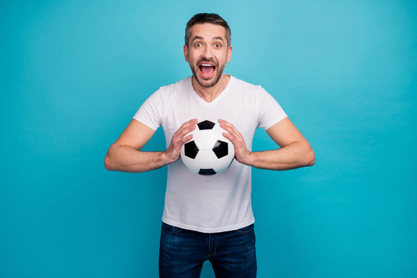Portrait of his he nice attractive addicted cheerful cheery glad bearded guy holding in hand ball throwing isolated over bright vivid shine vibrant blue color background - Foto, Imagem