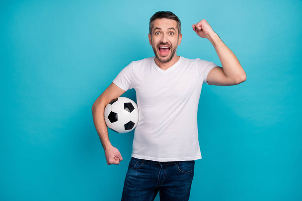 Portrait of his he nice attractive lucky cheerful cheery glad bearded guy holding in hand ball celebrating isolated over bright vivid shine vibrant blue color background - Foto, Imagem