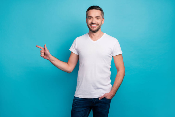Portrait of his he nice attractive content cheerful cheery bearded guy showing copy empty blank space isolated over bright vivid shine vibrant blue color background - Foto, afbeelding