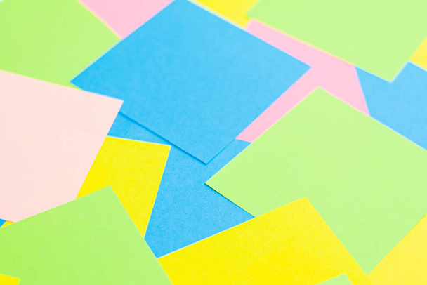 A set of office work related rainbow colored paper sticky notes. Isolated on cork background. - Foto, Bild