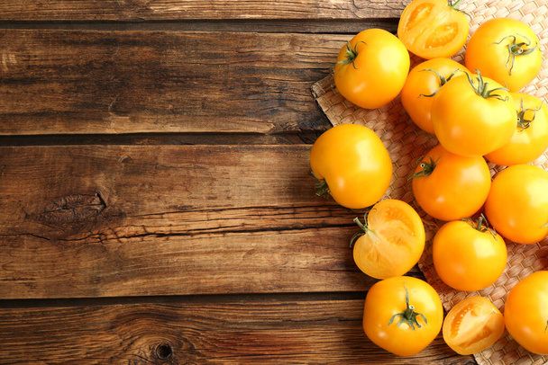 Ripe yellow tomatoes on wooden table, flat lay. Space for text - Фото, зображення