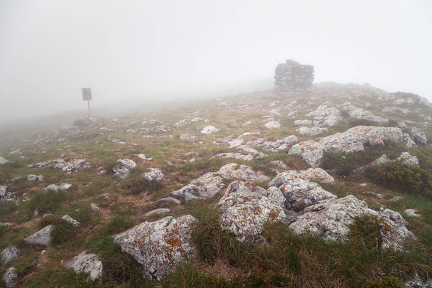 Foggy view of Trem summit stone and sign on Dry mountain (Suva planina) on a misty, wet, moody morning - Photo, Image